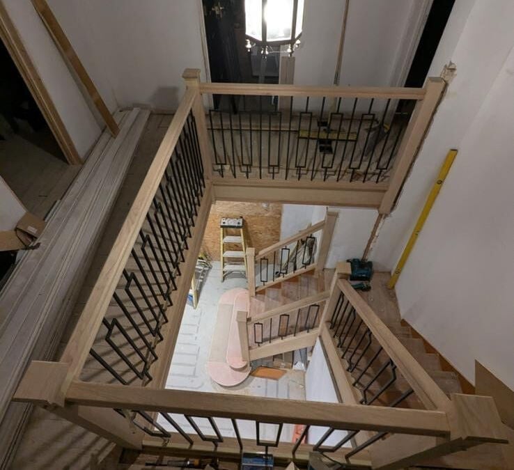New oak staircase with black metal spindles viewed from the landing