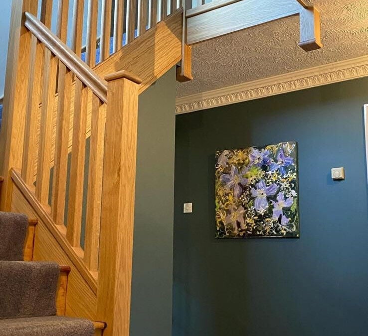 Pine staircase with a carpet runner in a hallway