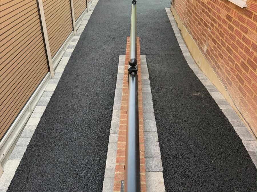 New tarmac side path with brick edging and a drainage channel