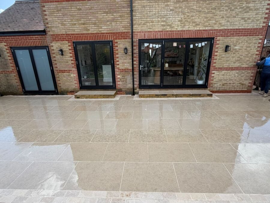 Large pale porcelain patio across the rear of a single storey extension