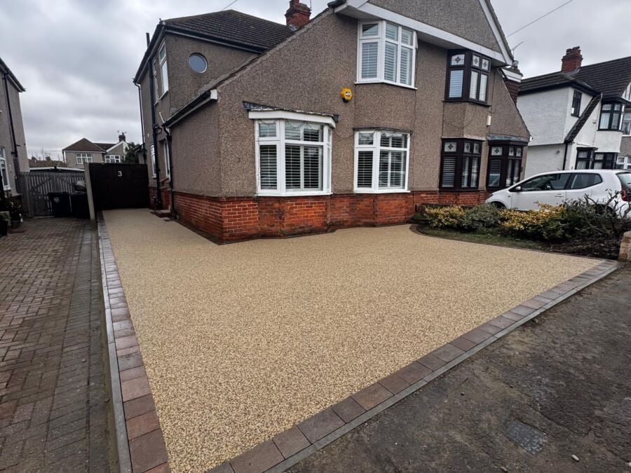 Resin bound driveway with a brick border in front of a semi detached house