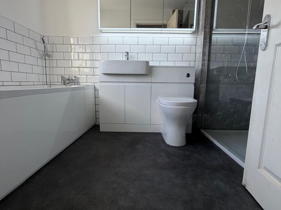 Bathroom with metro tiles, vanity unit, LED mirror and walk in shower