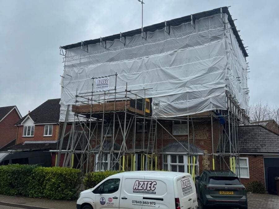 Scaffolding and protective sheeting around a house during building works