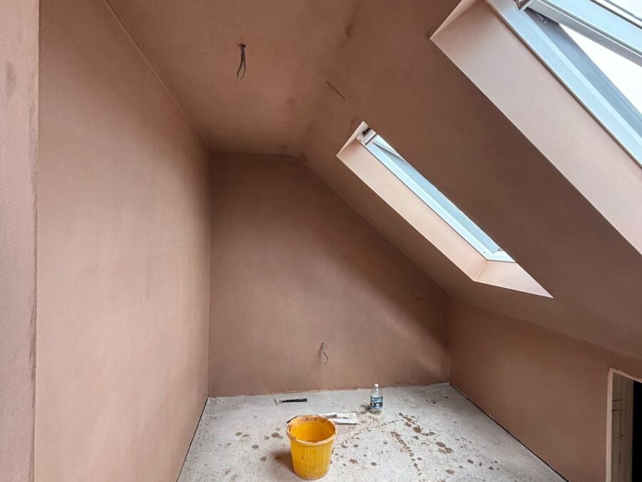 Loft room freshly plastered with two roof windows, ready for decorating