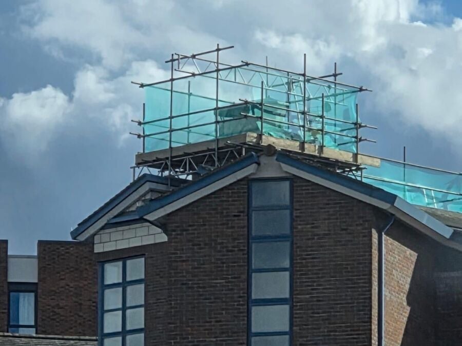 Scaffolding on the roof of a brick building for high level works