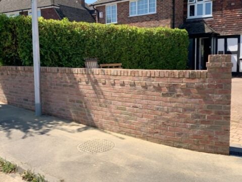 New red brick front garden wall with a brick pier